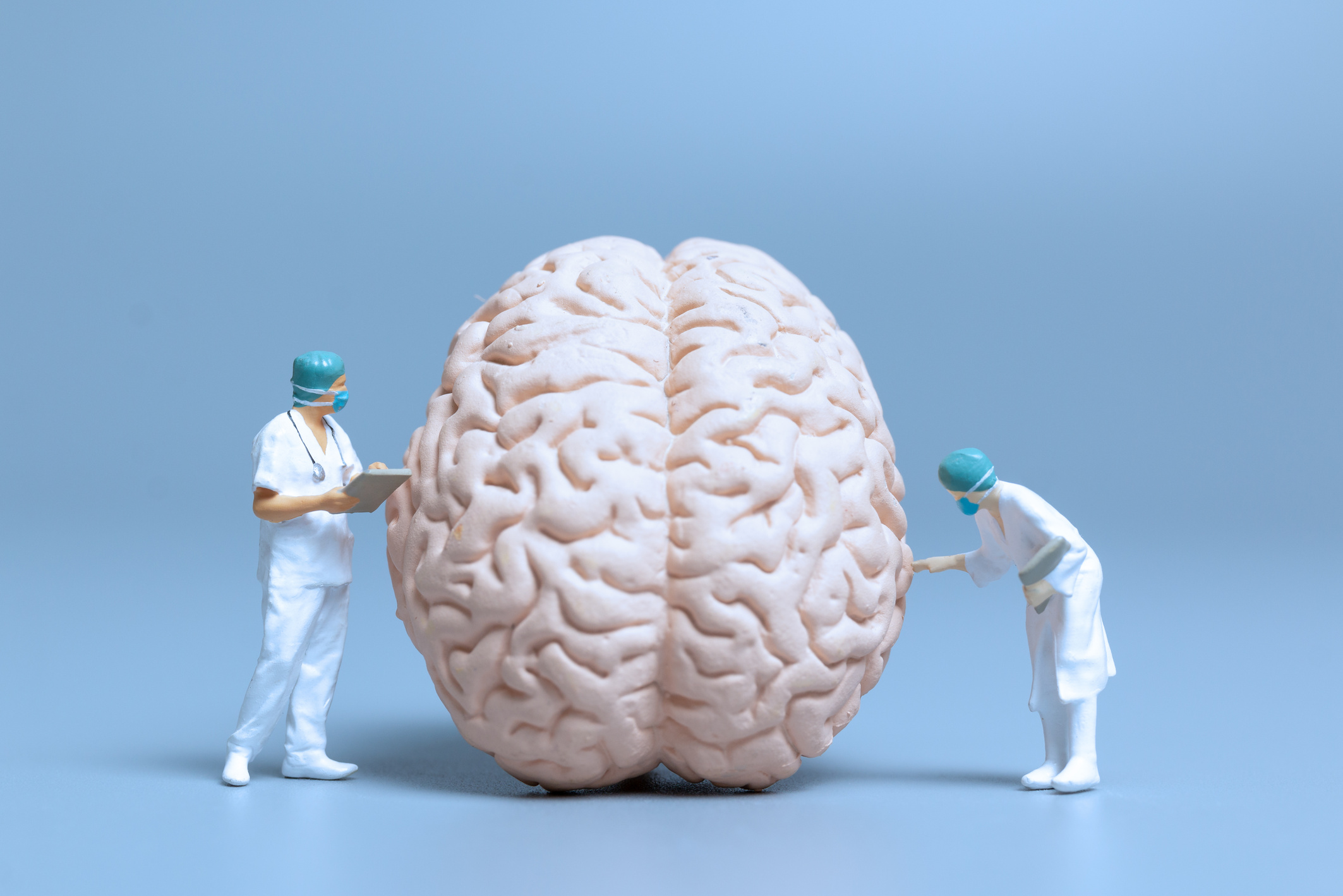 Doctor Figurines Examining Brain